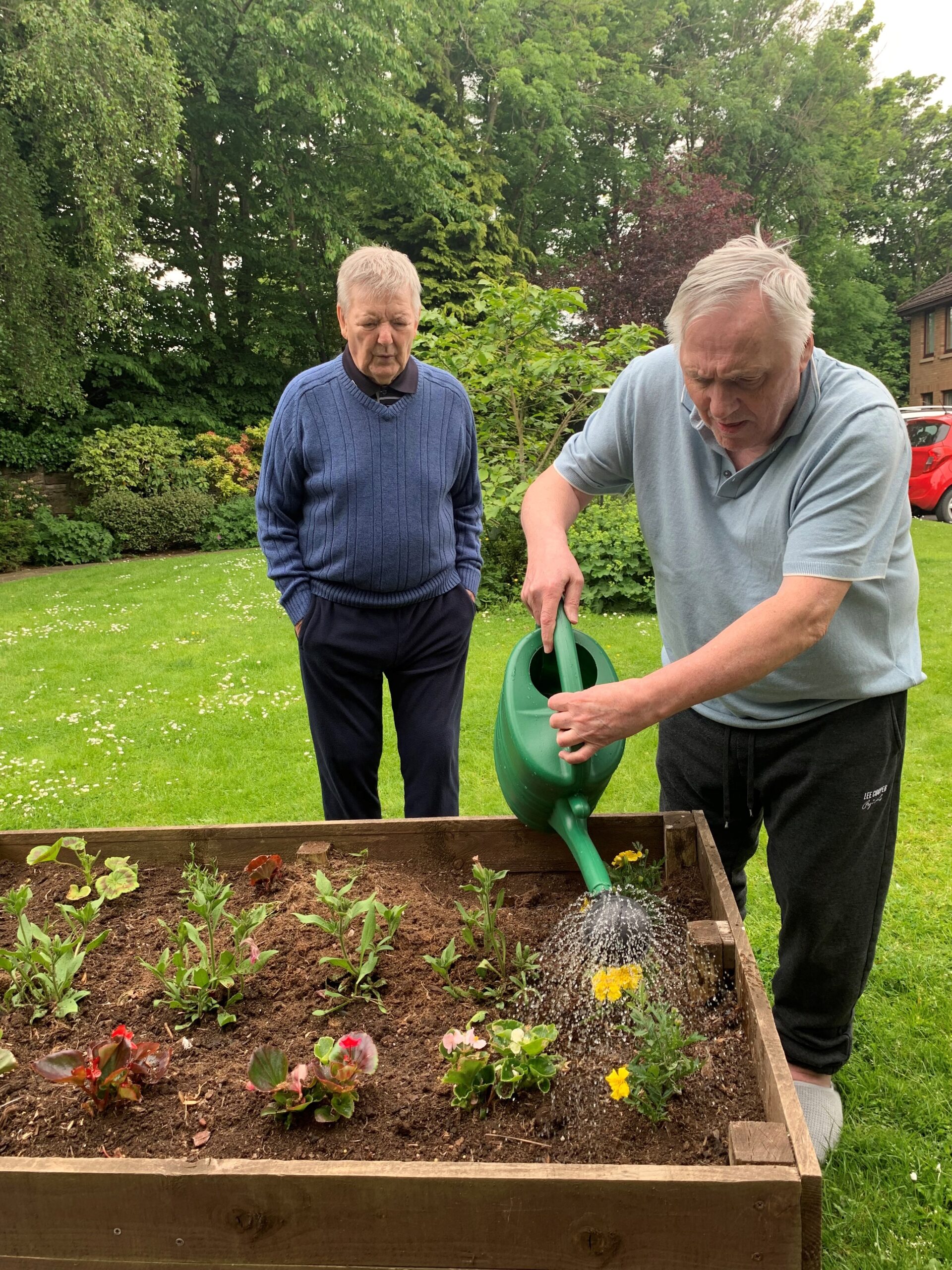 Residents Helping to Water Plants