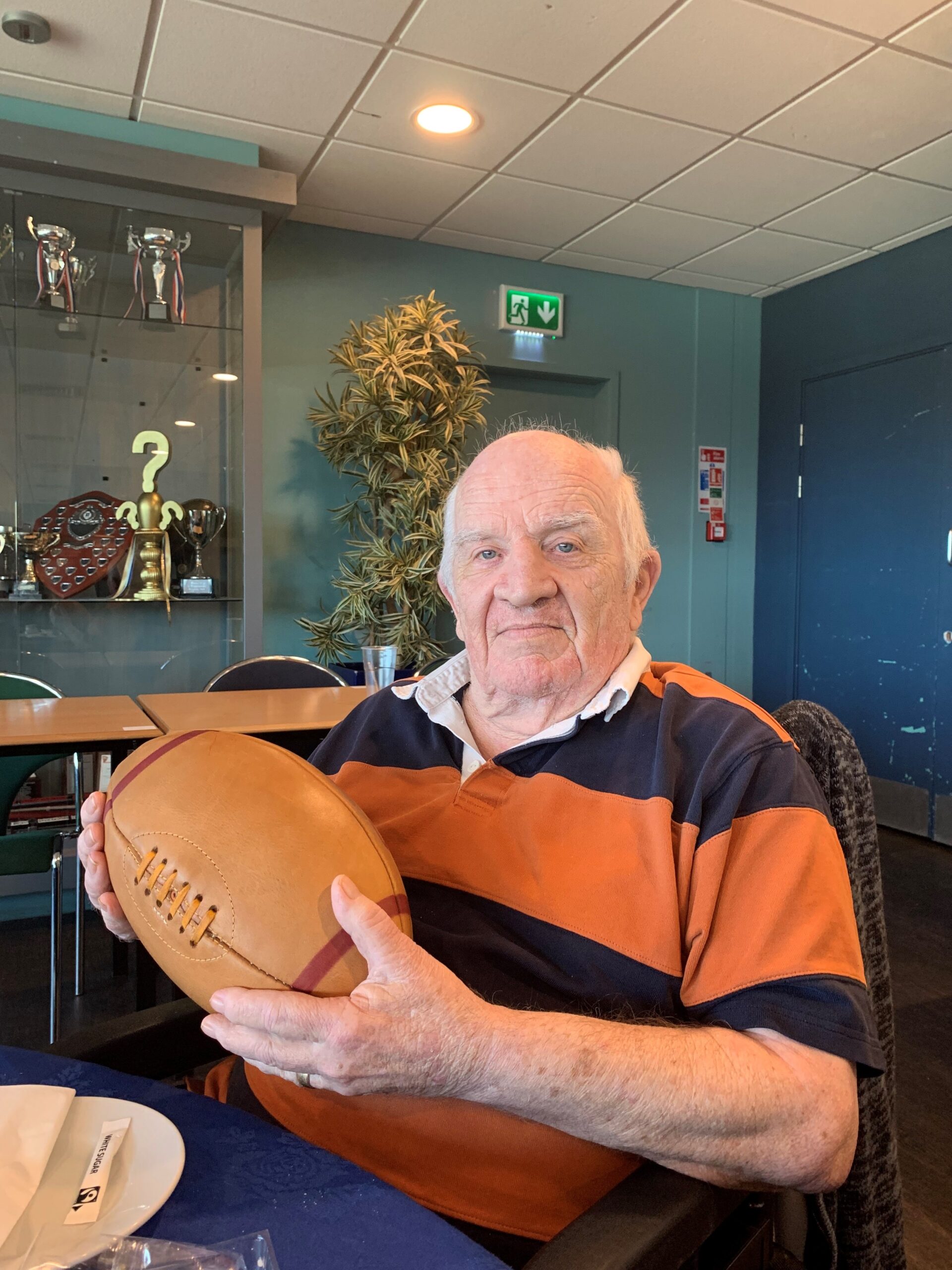 Resident Holding Leather Rugby Ball