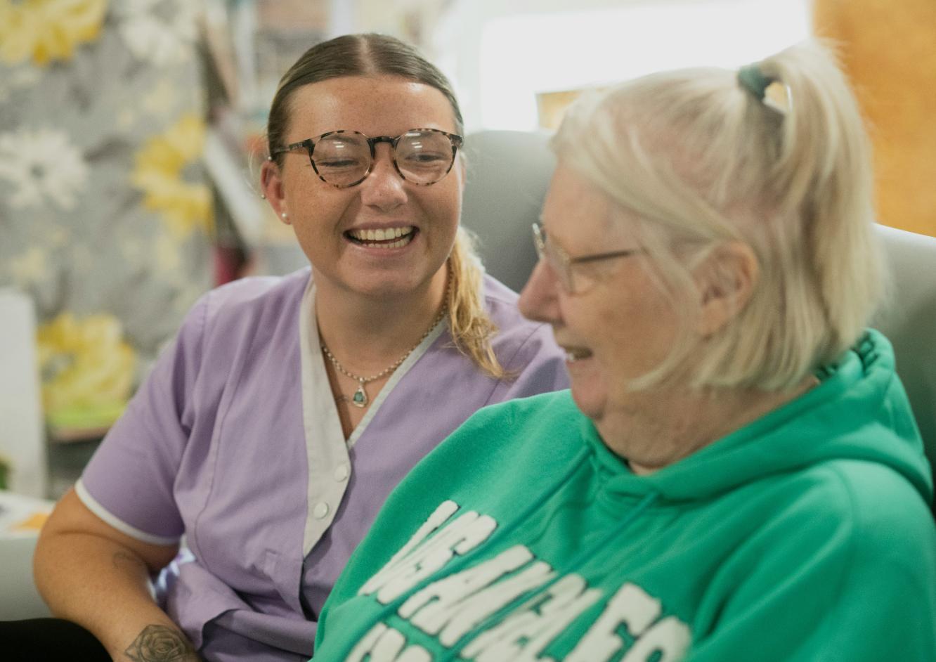 care assistant smiling with resident