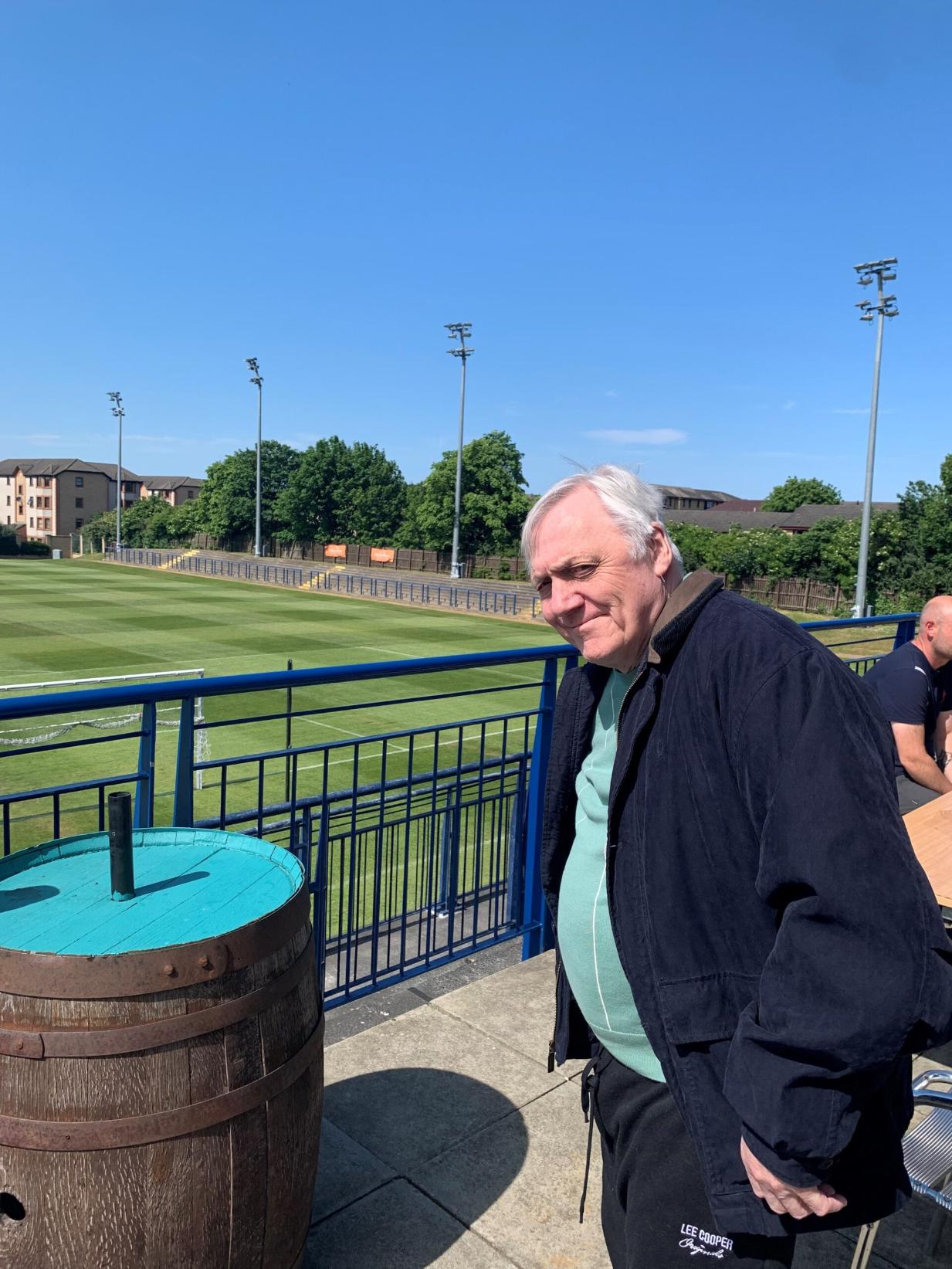 elderly man smiling at a local rugby club