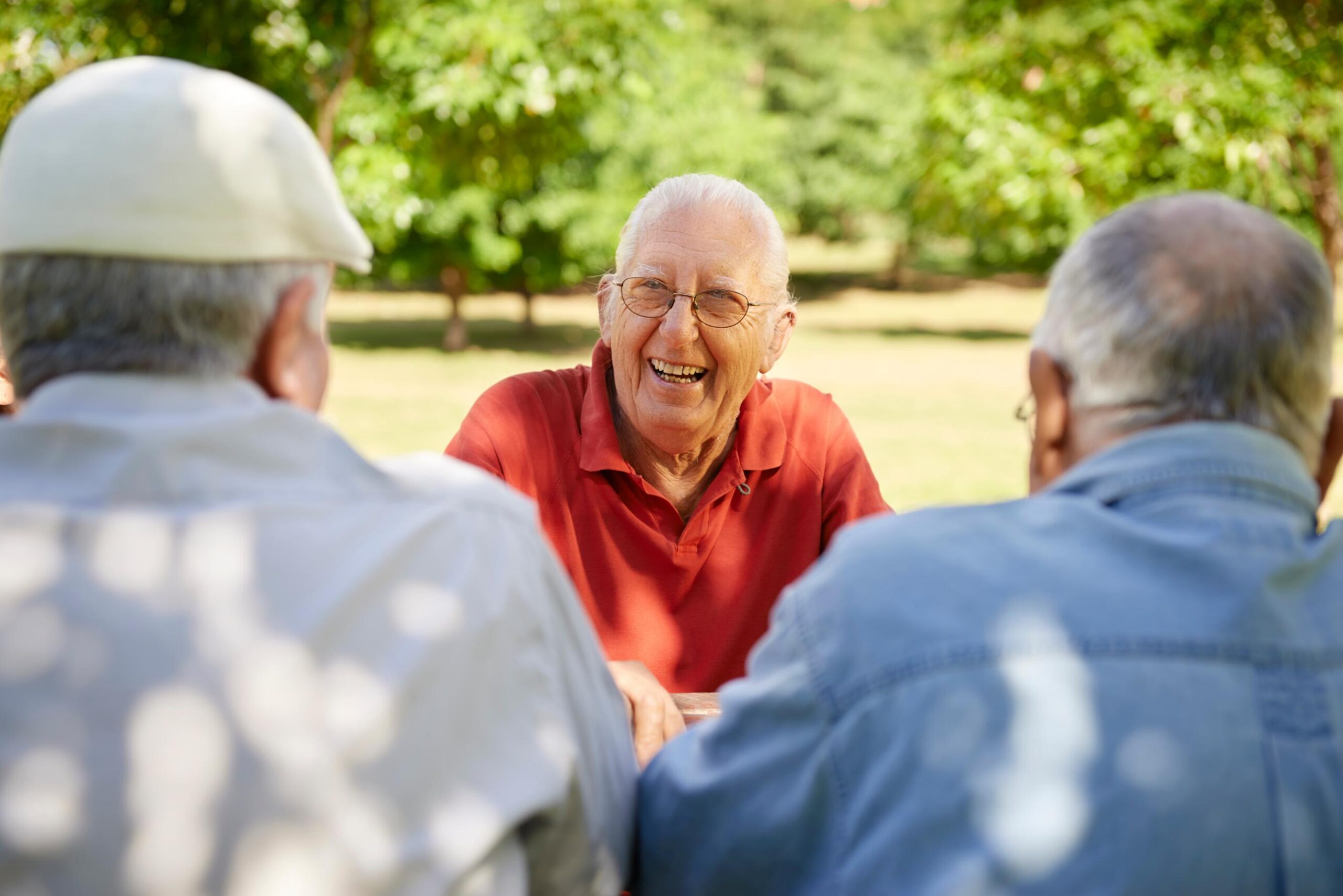 elderly men smiling outdoors