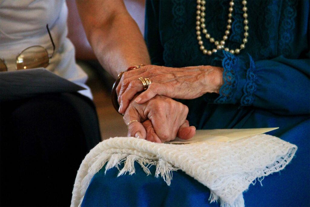 holding hands on a blanket